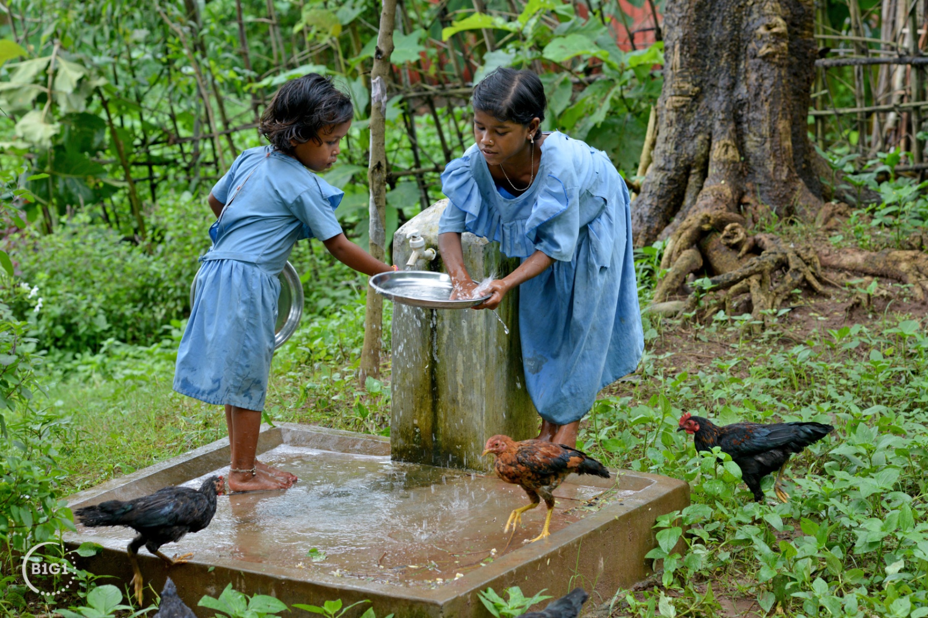 Children collecting clean water at a tap stand built through a B1G1 project