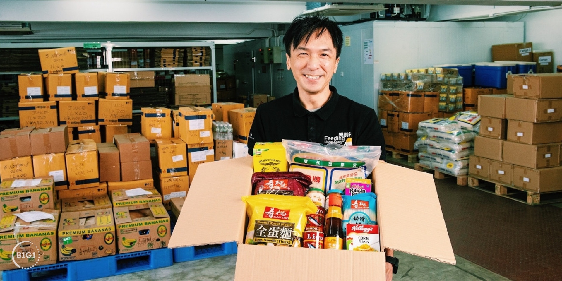 Volunteer preparing food parcels at a B1G1 partner distribution centre